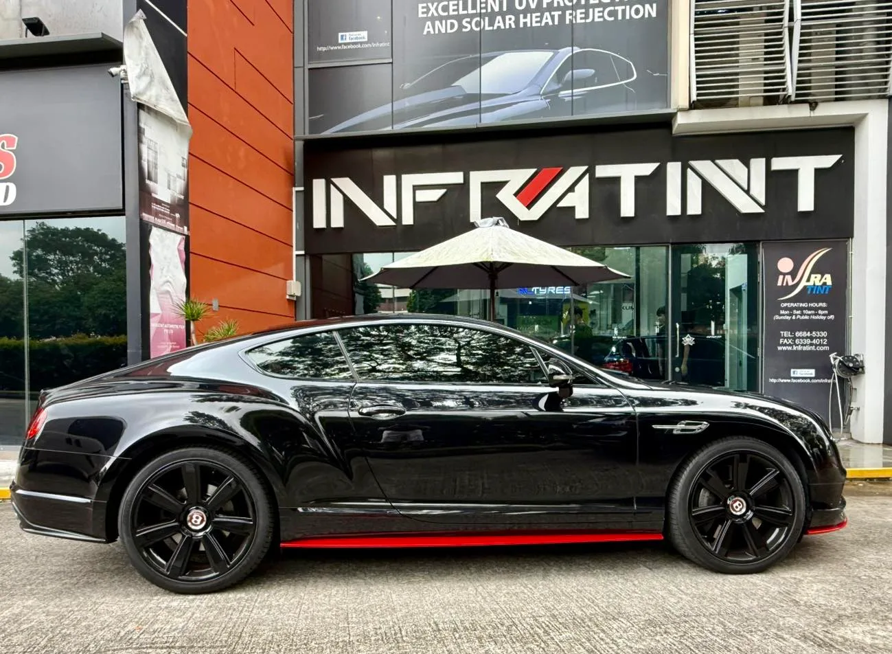 Black Bentley GT side profile with tinted glass and black wheels at Infratint Singapore