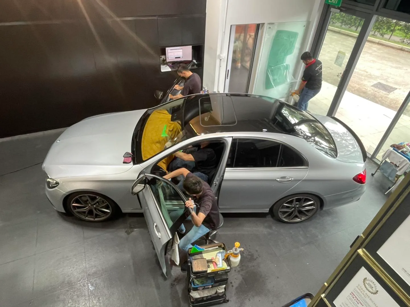 Overhead view of silver Mercedes-Benz E-Class window tinting at Infratint Singapore
