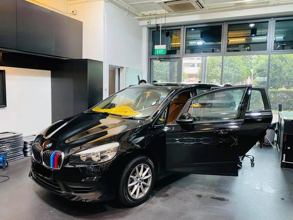 Black BMW 2 Series tourer with tan interior and doors open at Infratint Singapore