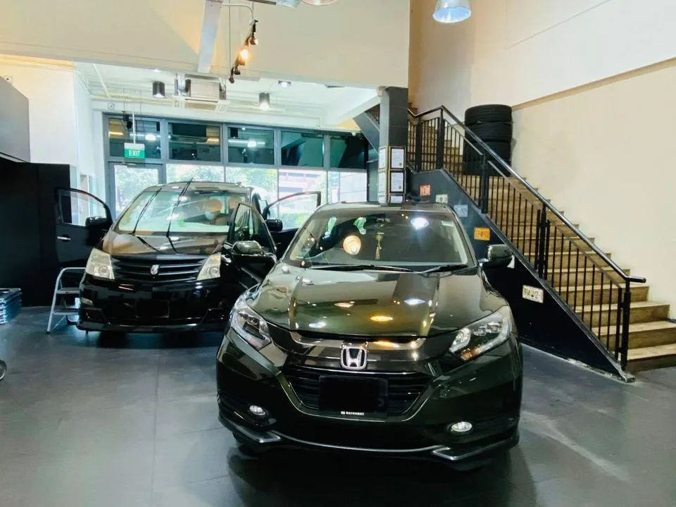 Black Honda SUV and a black MPV in the Infratint Singapore showroom