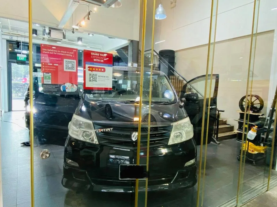 Black Toyota Alphard MPV behind the showroom glass at Infratint Singapore