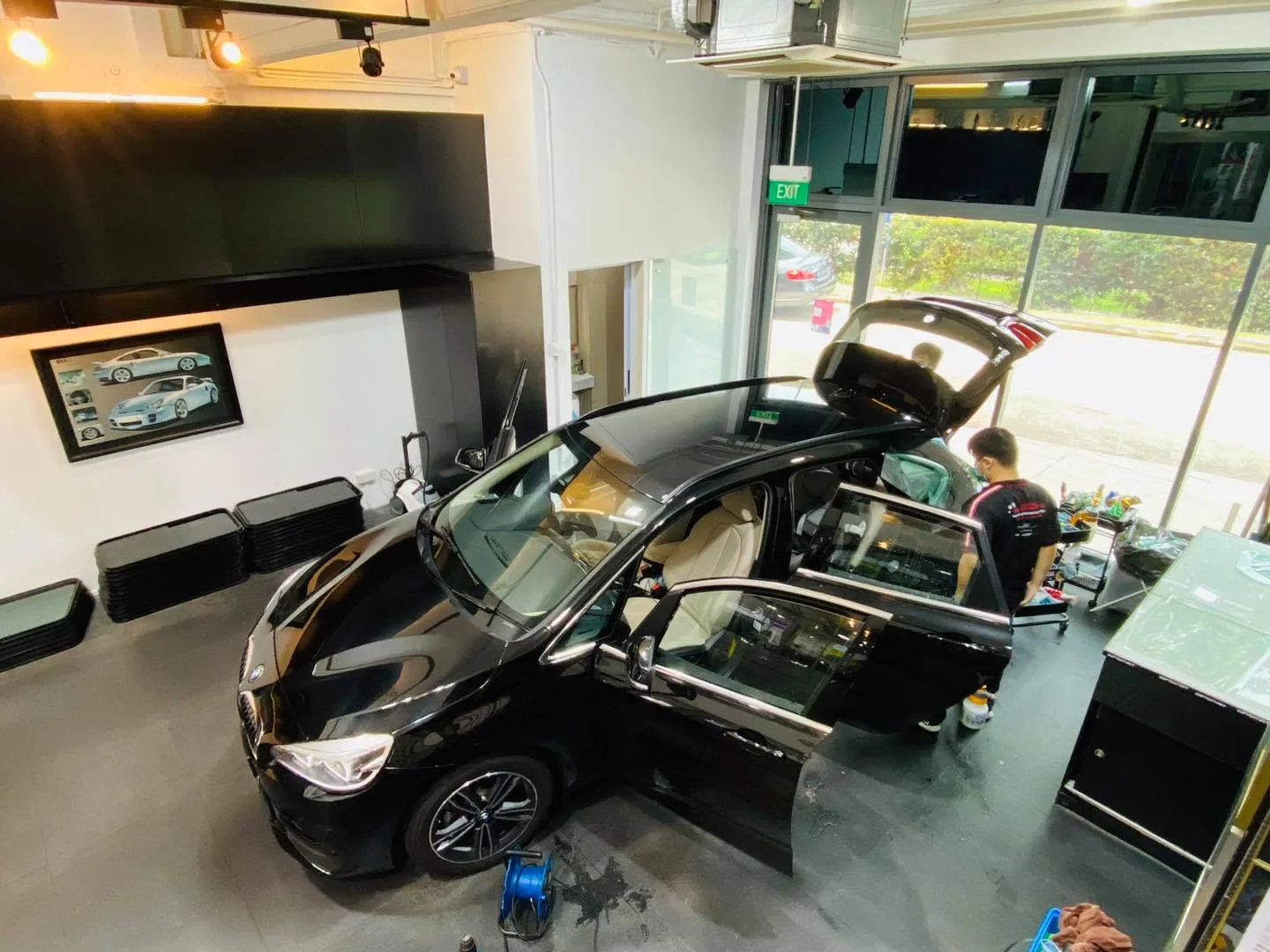Overhead view of a black MPV being window tinted at Infratint Singapore