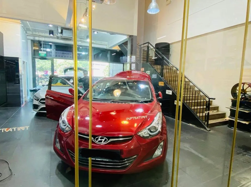 Red Hyundai Avante and white Mercedes-Benz at Infratint Singapore for window tinting