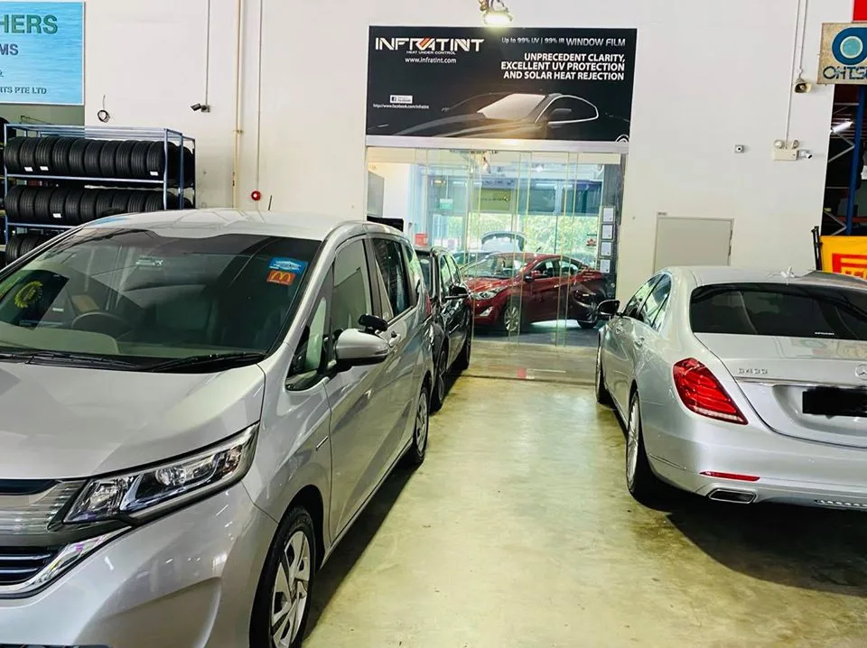 Silver Honda Freed and Mercedes-Benz S-Class under the Infratint banner in Singapore