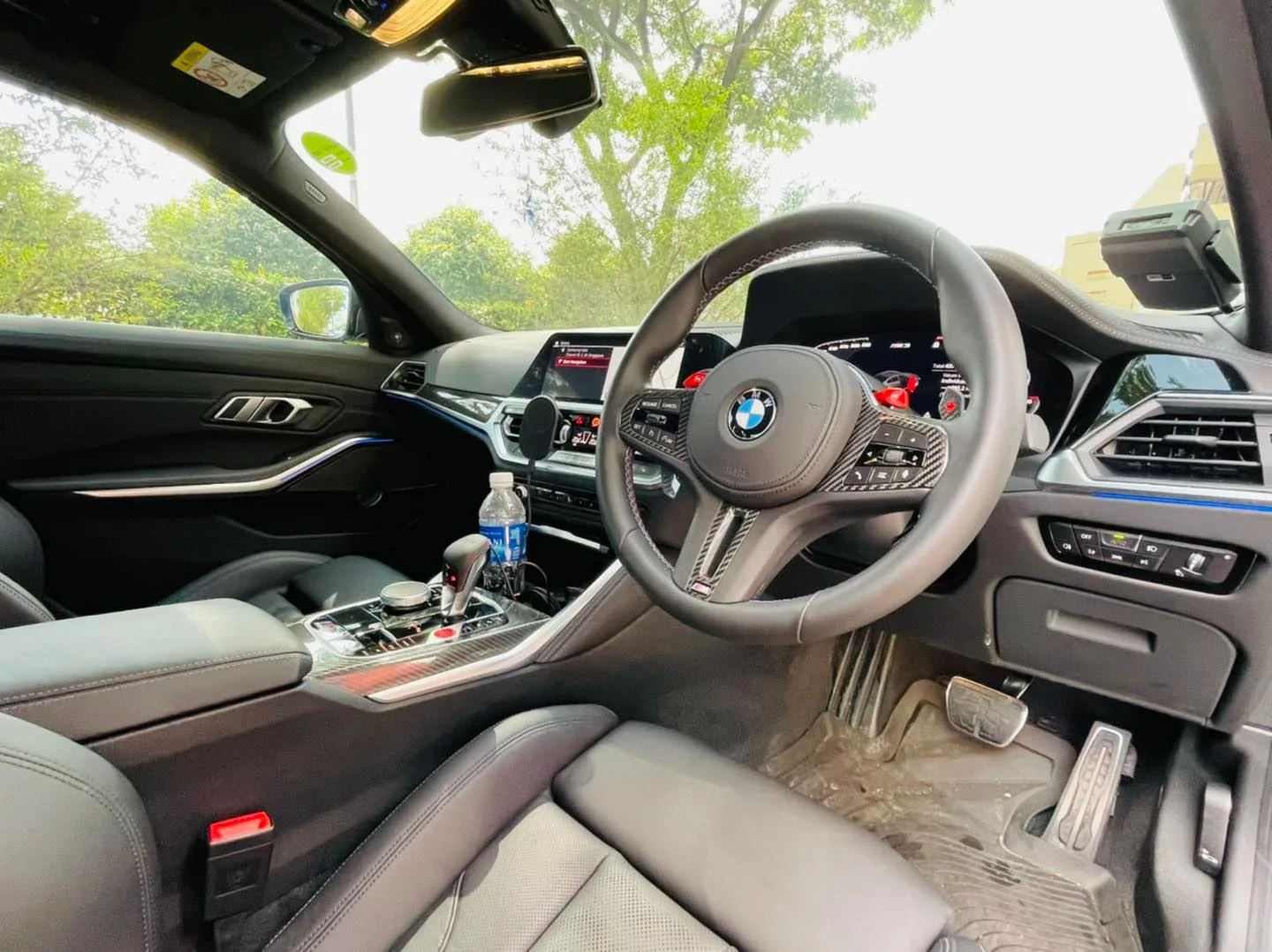 BMW M3 interior and steering wheel viewed through tinted windows at Infratint Singapore