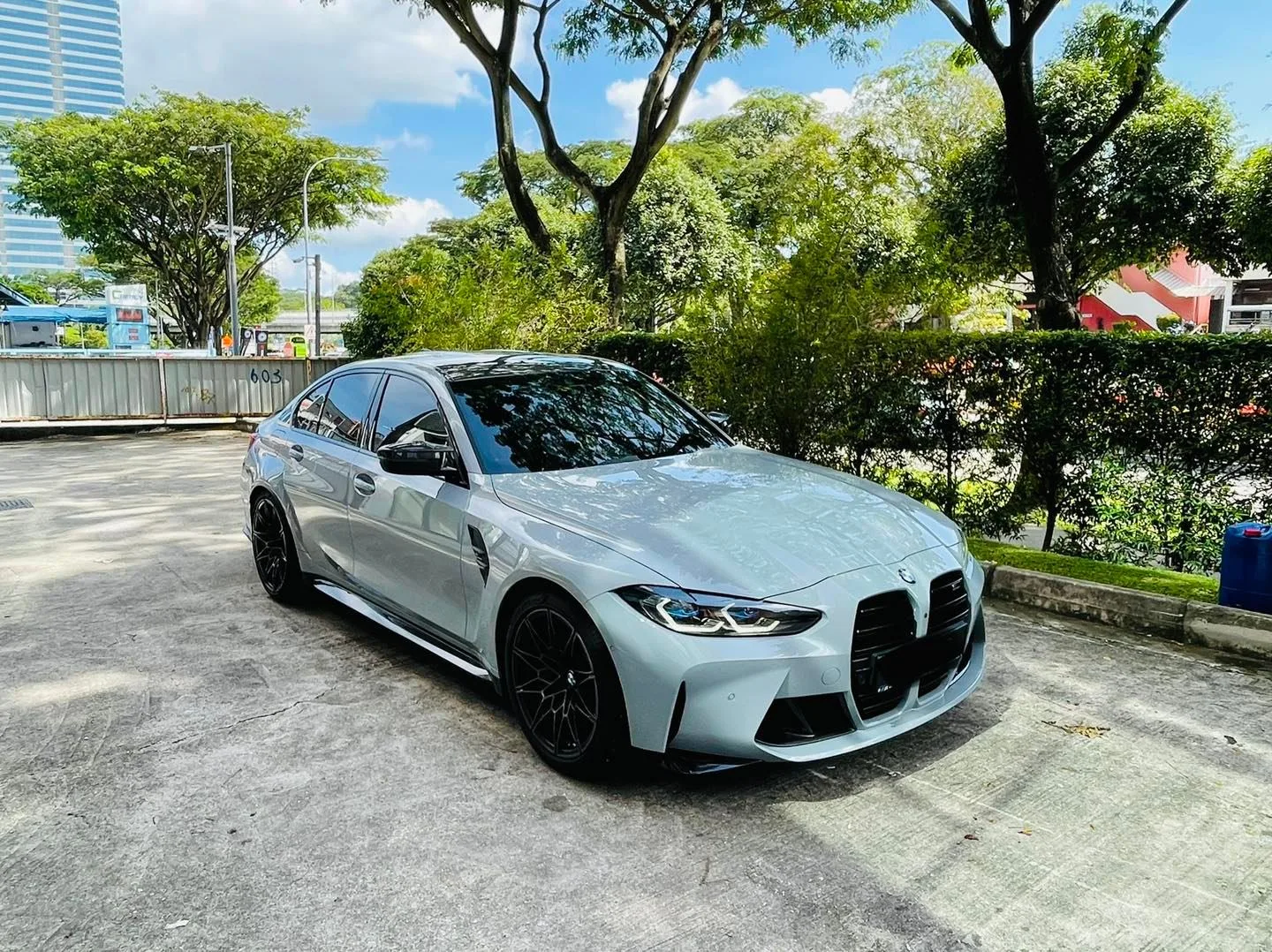 Grey BMW M3 front three-quarter outdoors after window tinting at Infratint Singapore