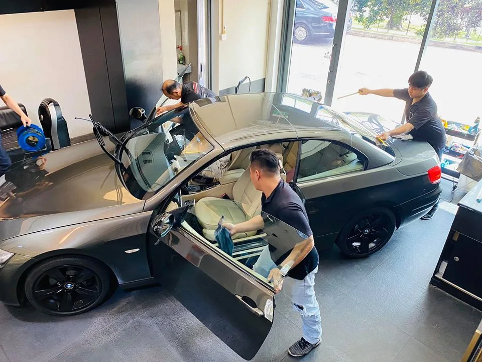Overhead view of a grey two-door BMW with cream interior being tinted at Infratint Singapore