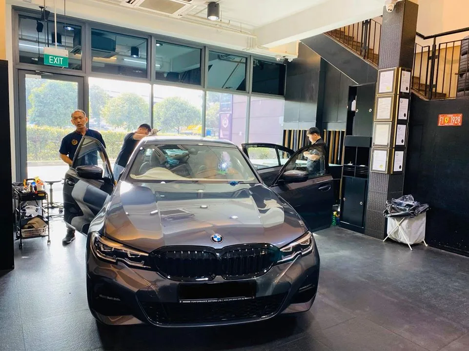 Grey BMW 3 Series with doors open during window tinting at Infratint Singapore