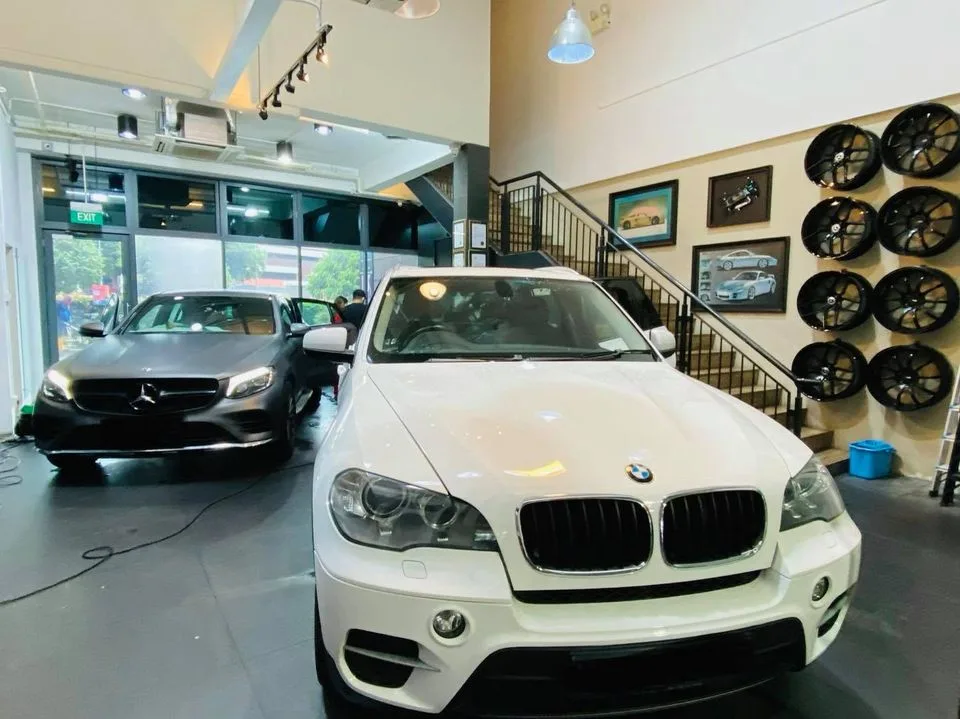 White BMW X5 and matte grey Mercedes-Benz at Infratint Singapore for window film