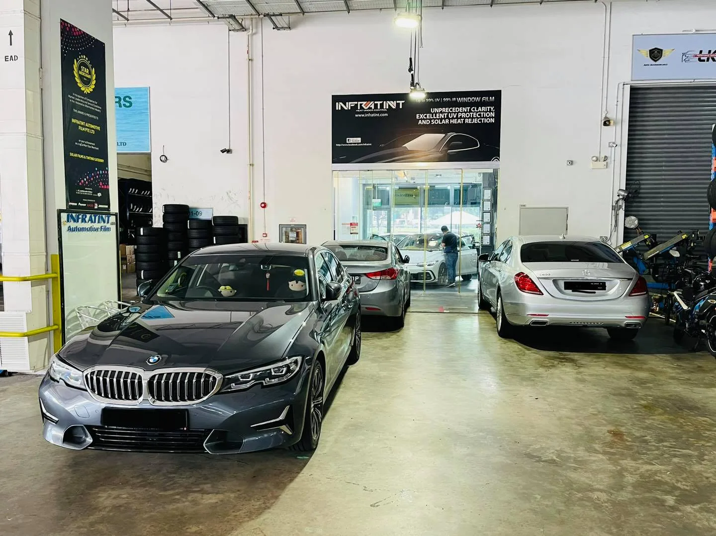 Grey BMW 3 Series and white Mercedes-Benz S-Class at Infratint Singapore for tinting