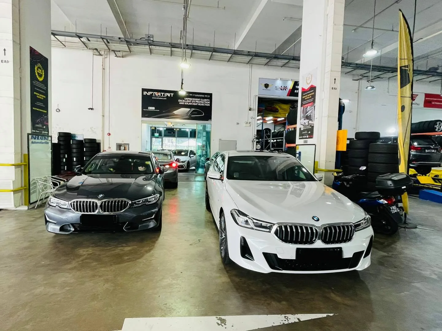 Grey and white BMWs parked side by side at Infratint Singapore