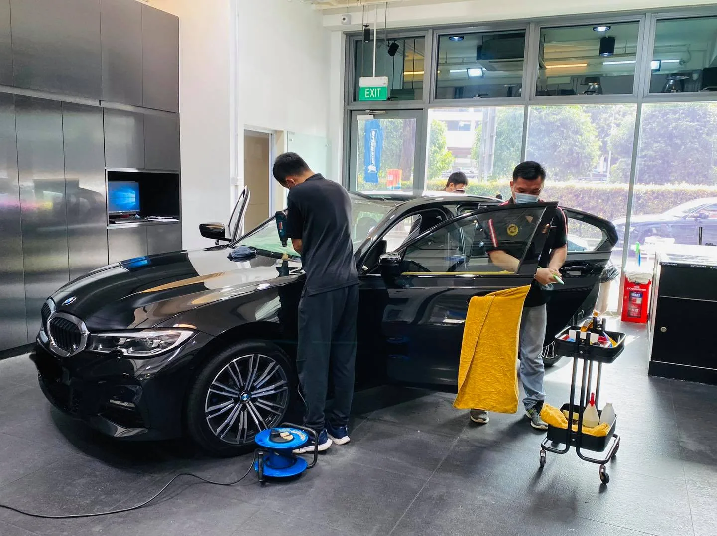 Black BMW 3 Series side view during window film install at Infratint Singapore