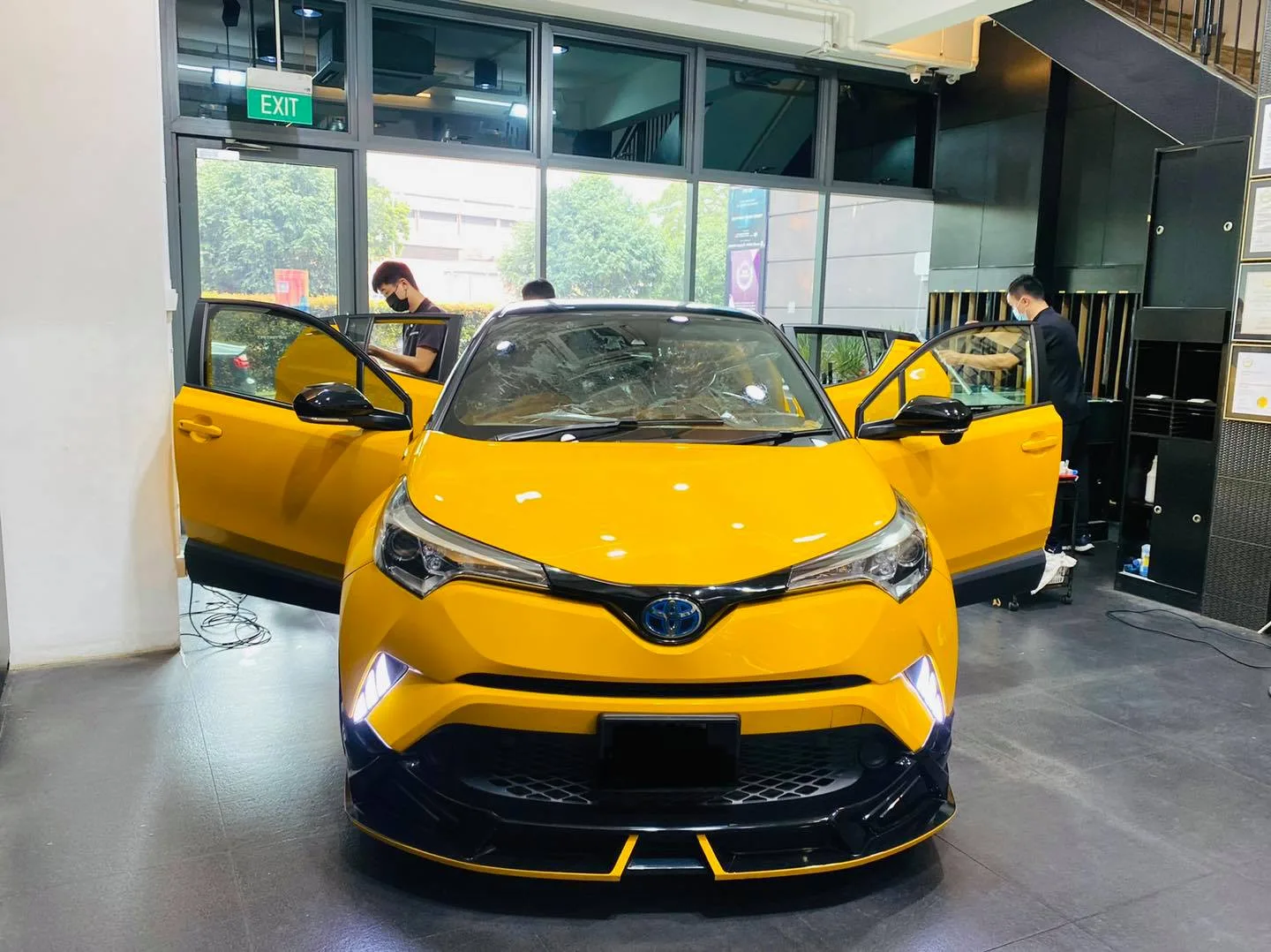 Yellow Toyota C-HR with doors open for window tinting at Infratint Singapore