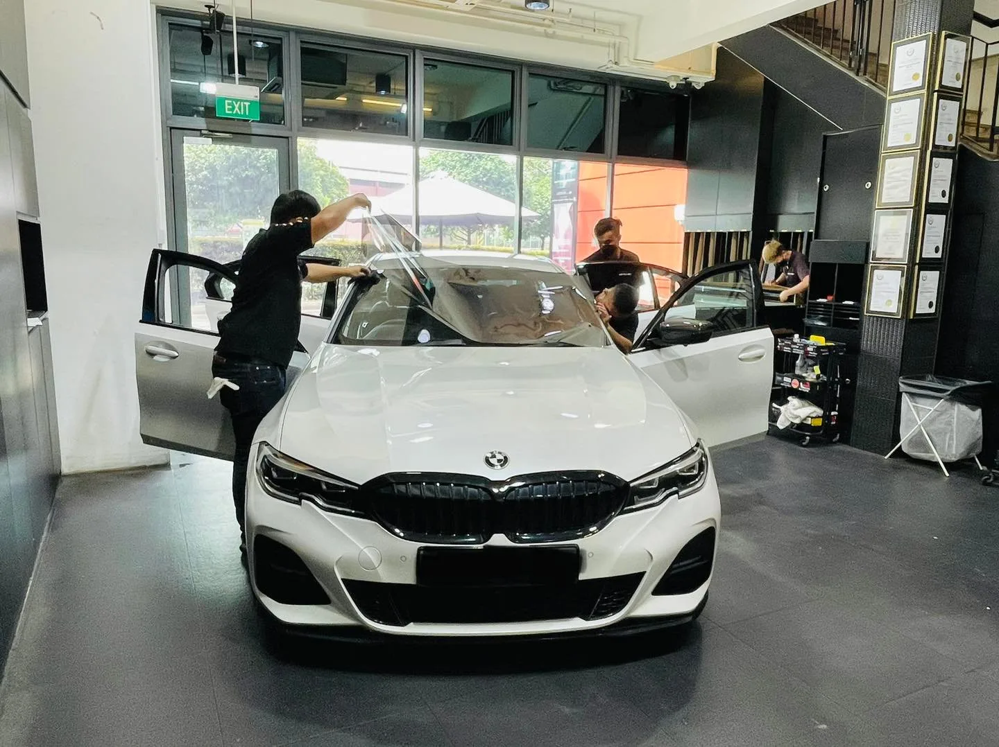 White BMW 3 Series sedan having window film fitted at Infratint Singapore