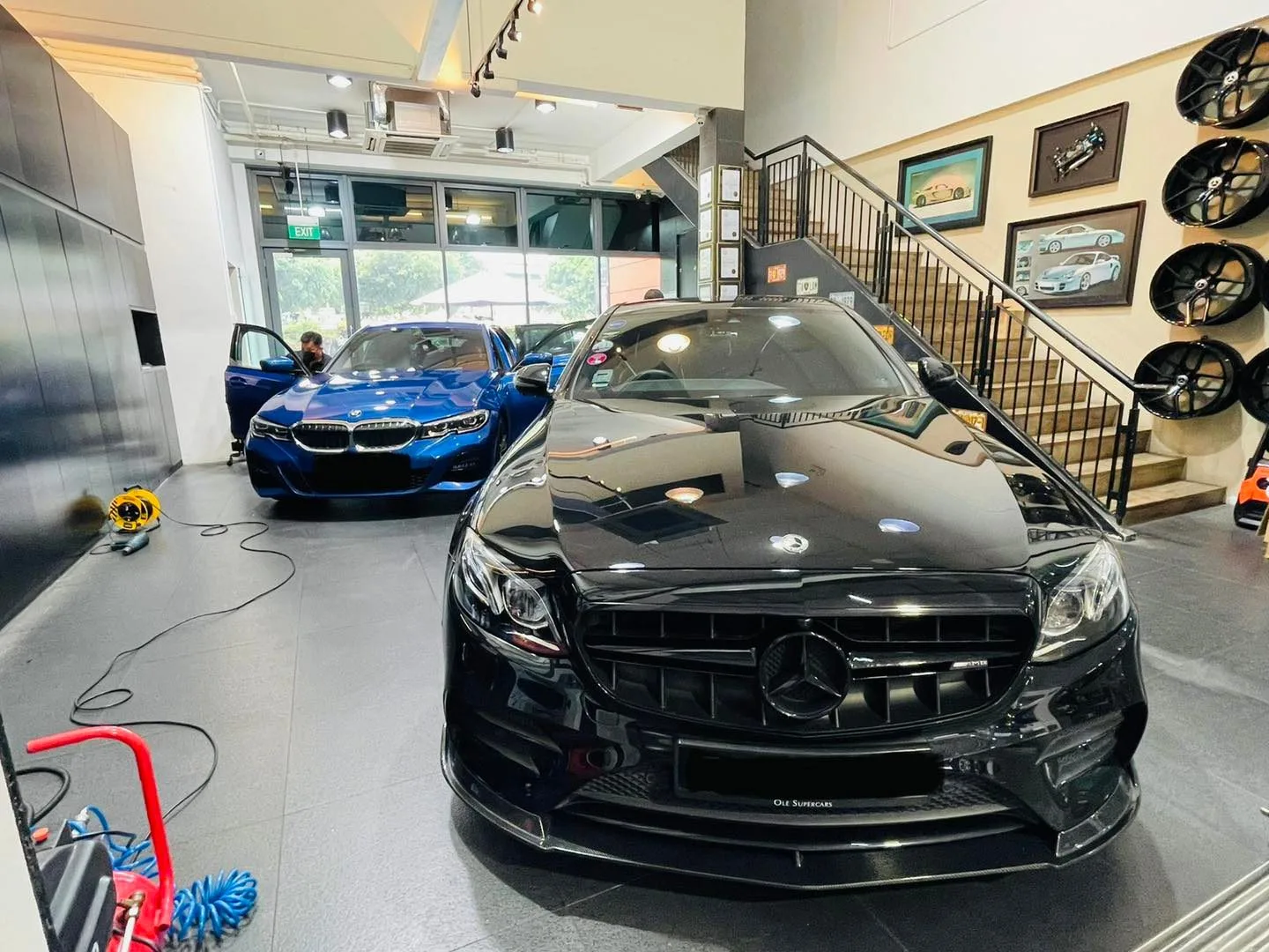 Black Mercedes-Benz E-Class and blue BMW inside Infratint Singapore