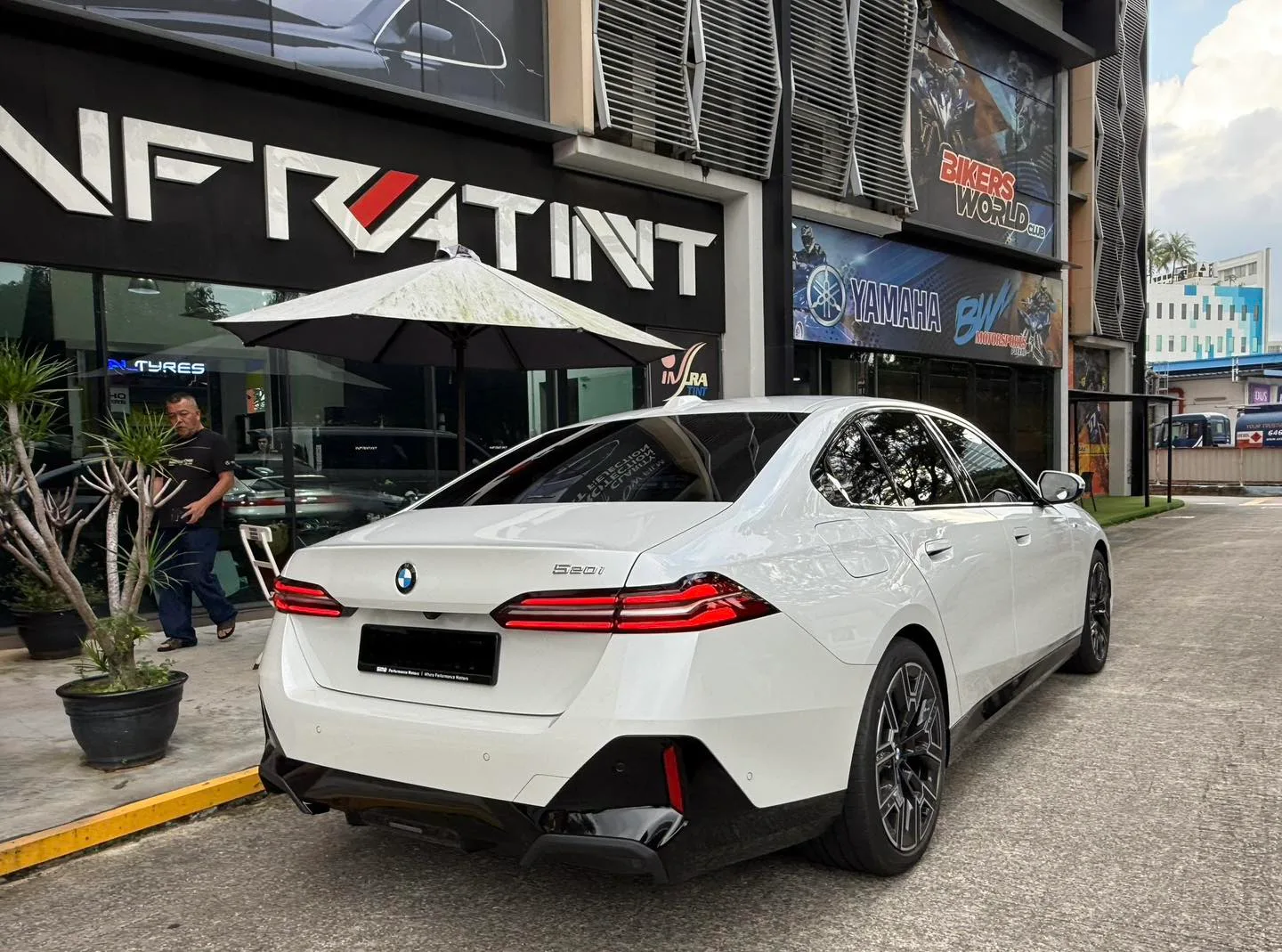 White BMW 520i rear three-quarter view with tinted windows at Infratint Singapore