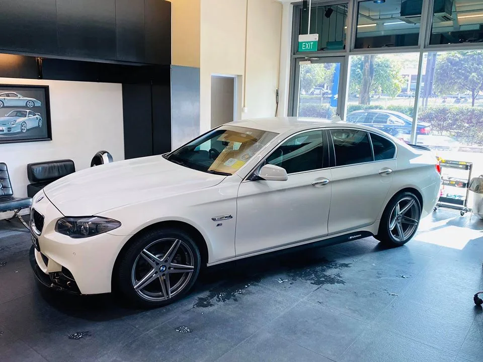 White BMW 5 Series sedan with tinted windows at Infratint Singapore