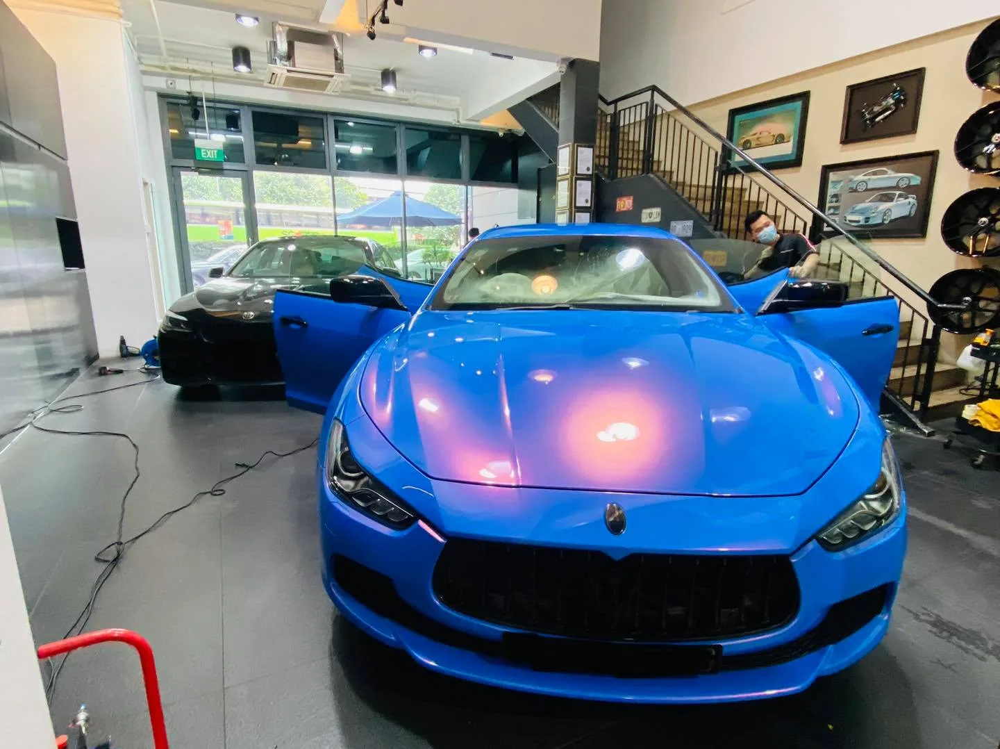 Blue Maserati Ghibli and black BMW inside Infratint Singapore for window tinting
