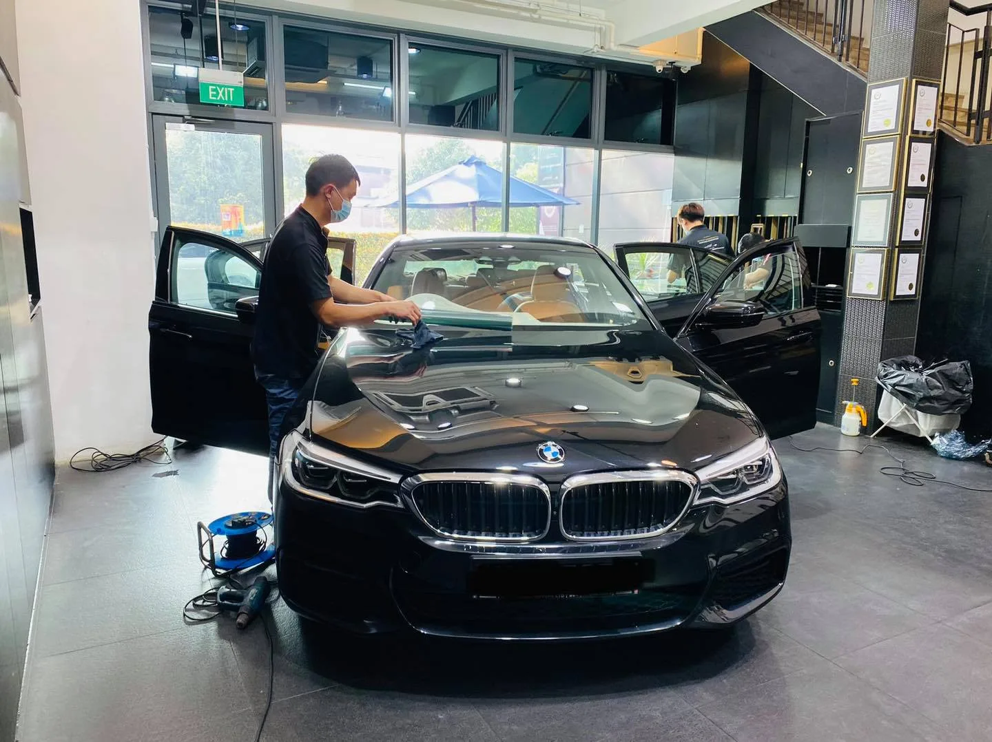 Black BMW 5 Series sedan getting windscreen film at Infratint Singapore