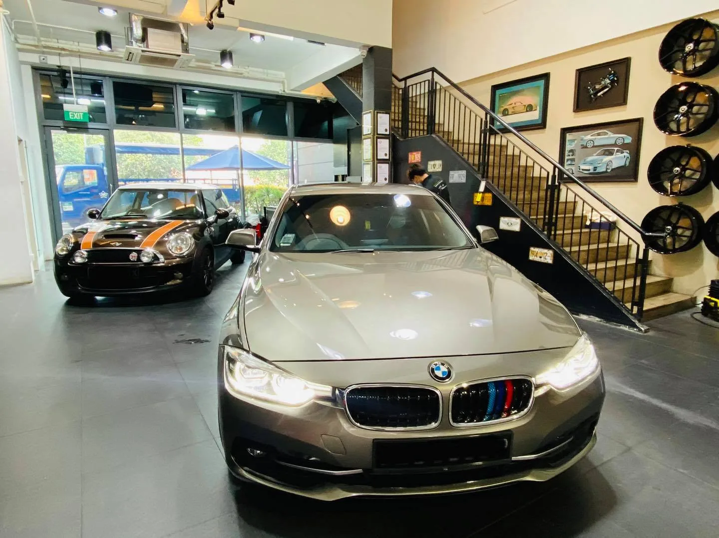 Champagne BMW 3 Series and a black Mini inside Infratint Singapore