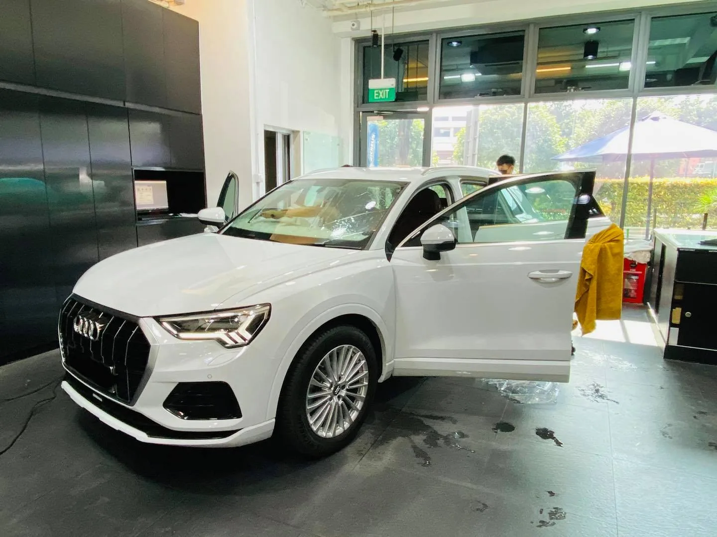 Side profile of a white Audi Q3 during window tinting at Infratint Singapore