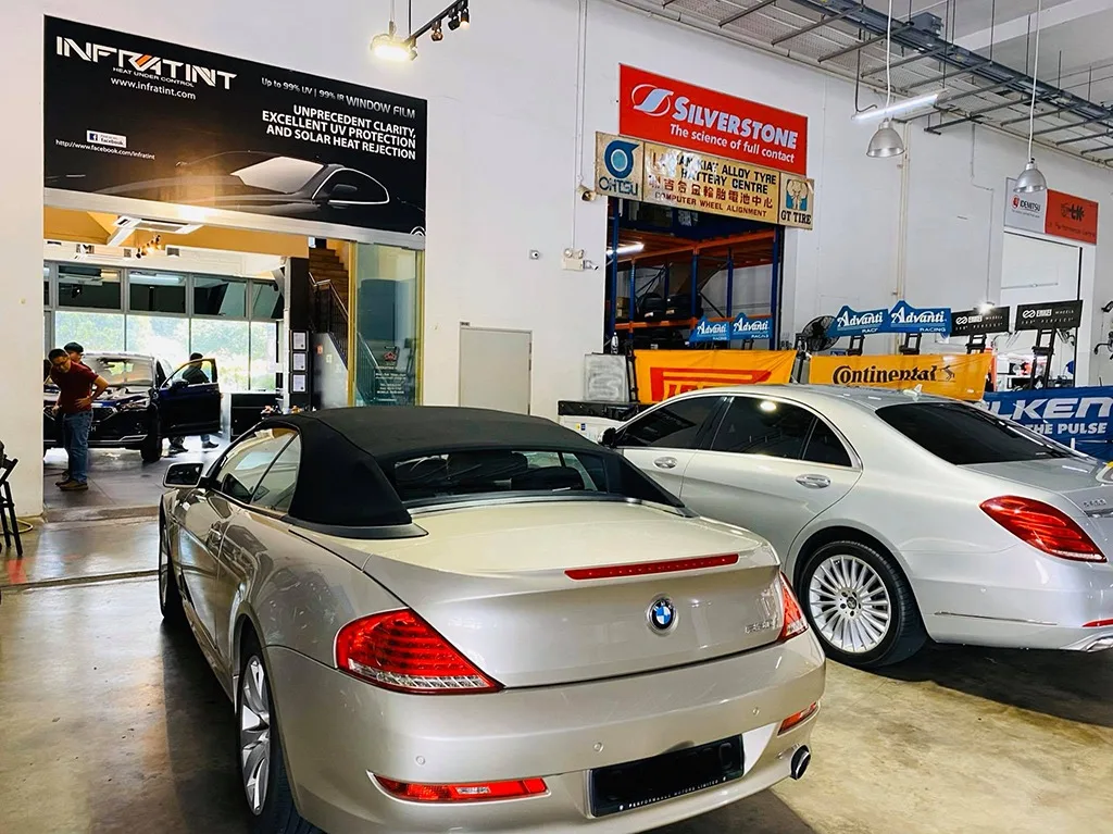 Champagne BMW 6 Series convertible and silver Mercedes-Benz S-Class inside Infratint Singapore