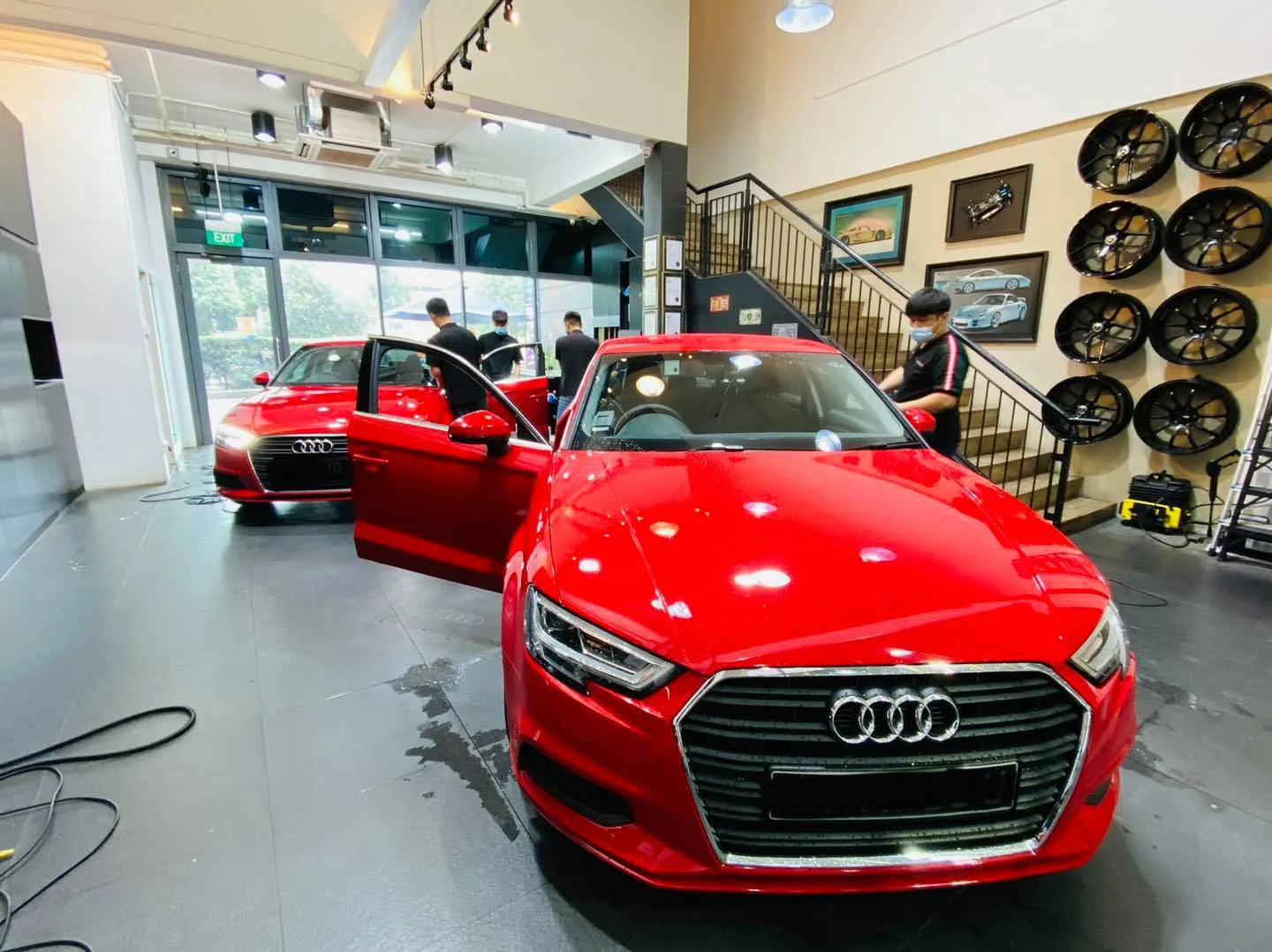 Two red Audi sedans during window tinting at Infratint Singapore