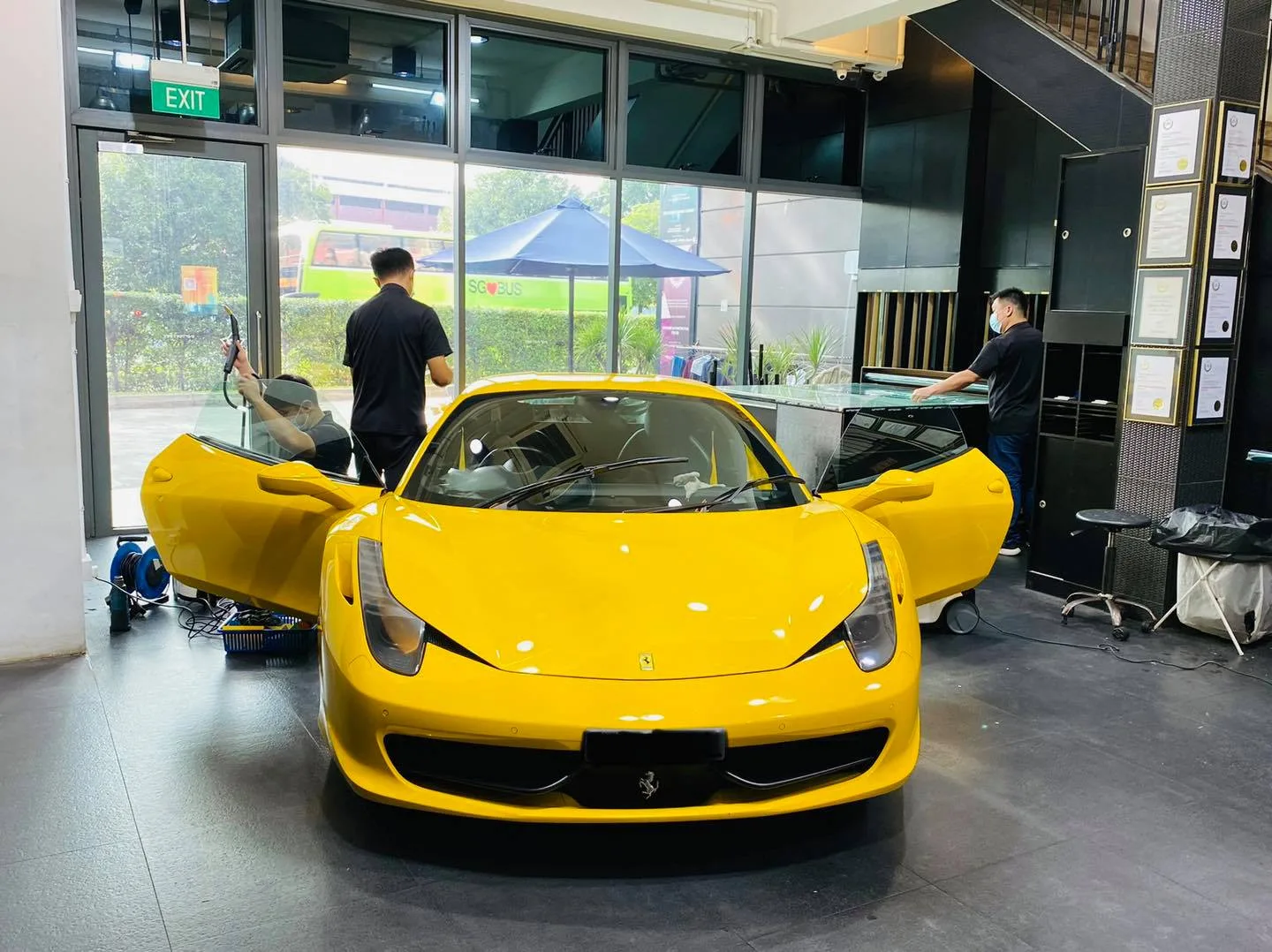 Yellow Ferrari 458 front view during window film install at Infratint Singapore