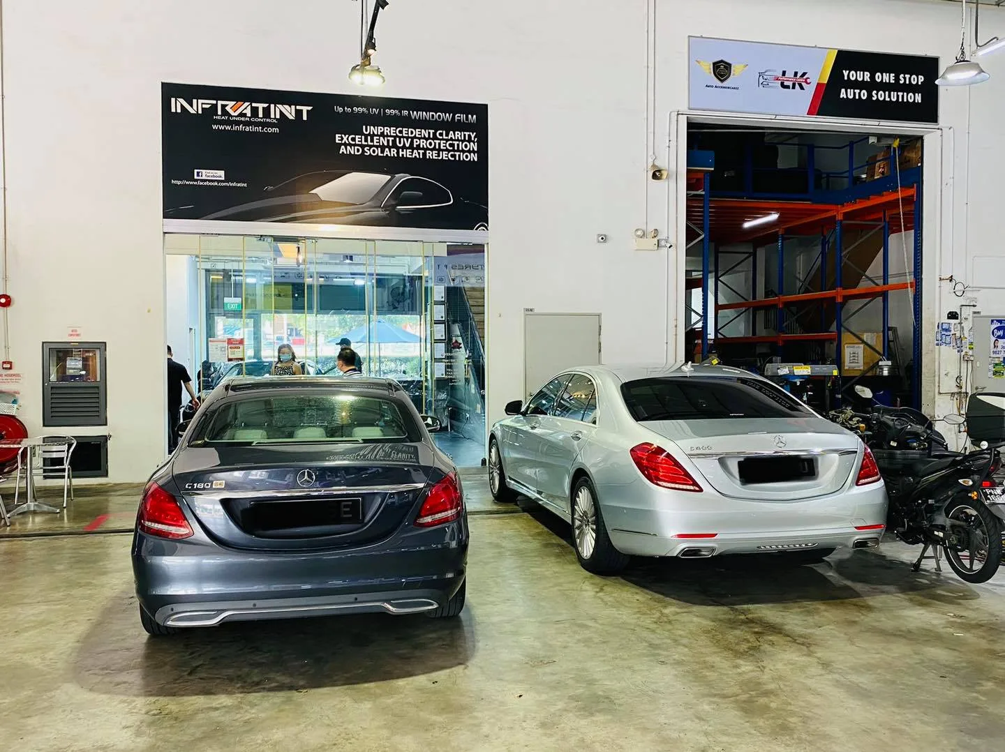 Grey Mercedes-Benz C-Class and silver S-Class parked under the Infratint Singapore banner
