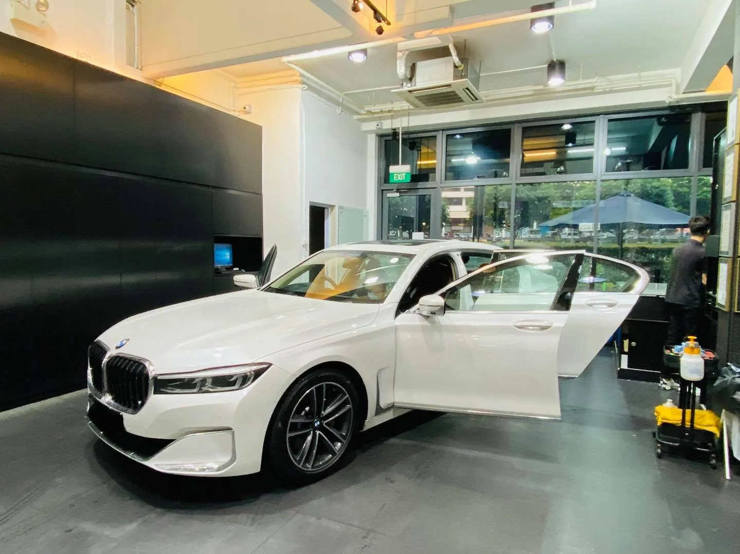 White BMW 7 Series with door open during window tinting at Infratint Singapore