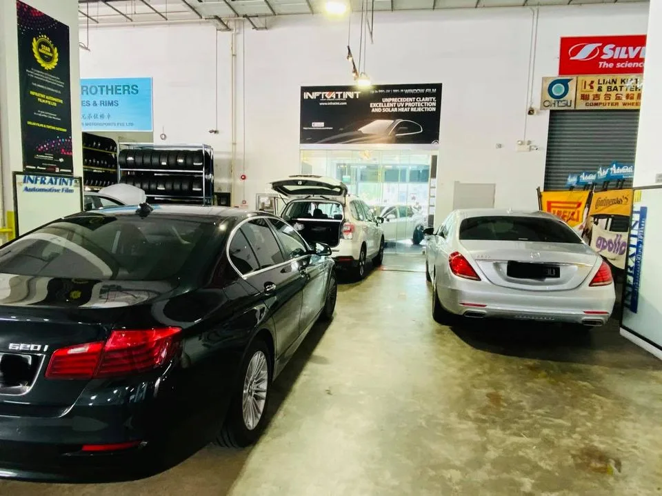 Black BMW 520i and silver Mercedes-Benz S-Class from behind at Infratint Singapore