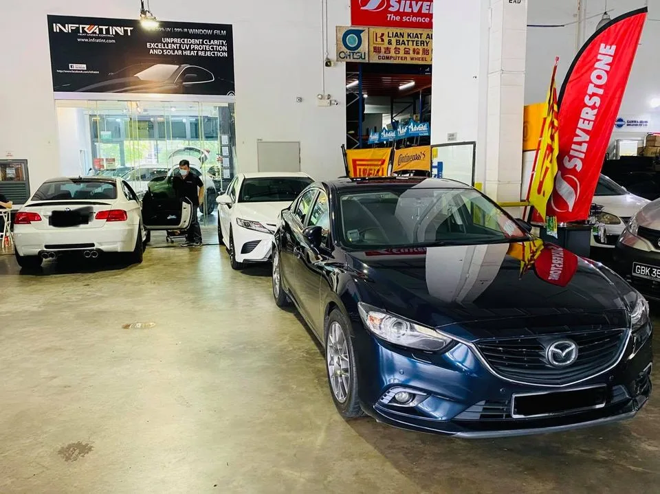 Dark blue Mazda 6 with a white BMW M3 behind at Infratint Singapore
