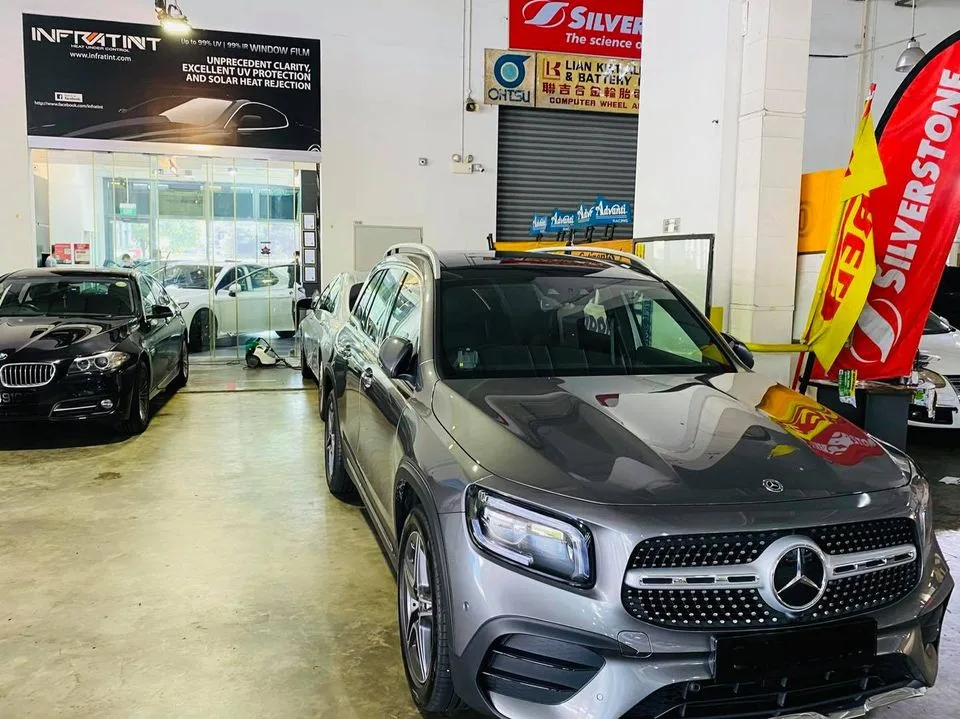 Grey Mercedes-Benz GLB SUV and black BMW at Infratint Singapore for window tinting