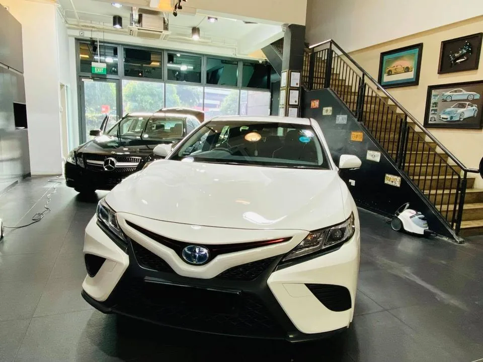 White Toyota Camry head-on with a black Mercedes-Benz at Infratint Singapore