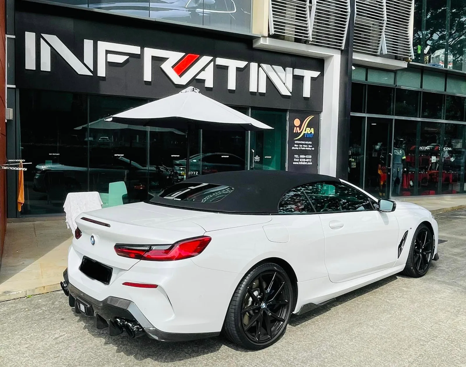 Rear three-quarter view of a white BMW 8 Series convertible at Infratint Singapore