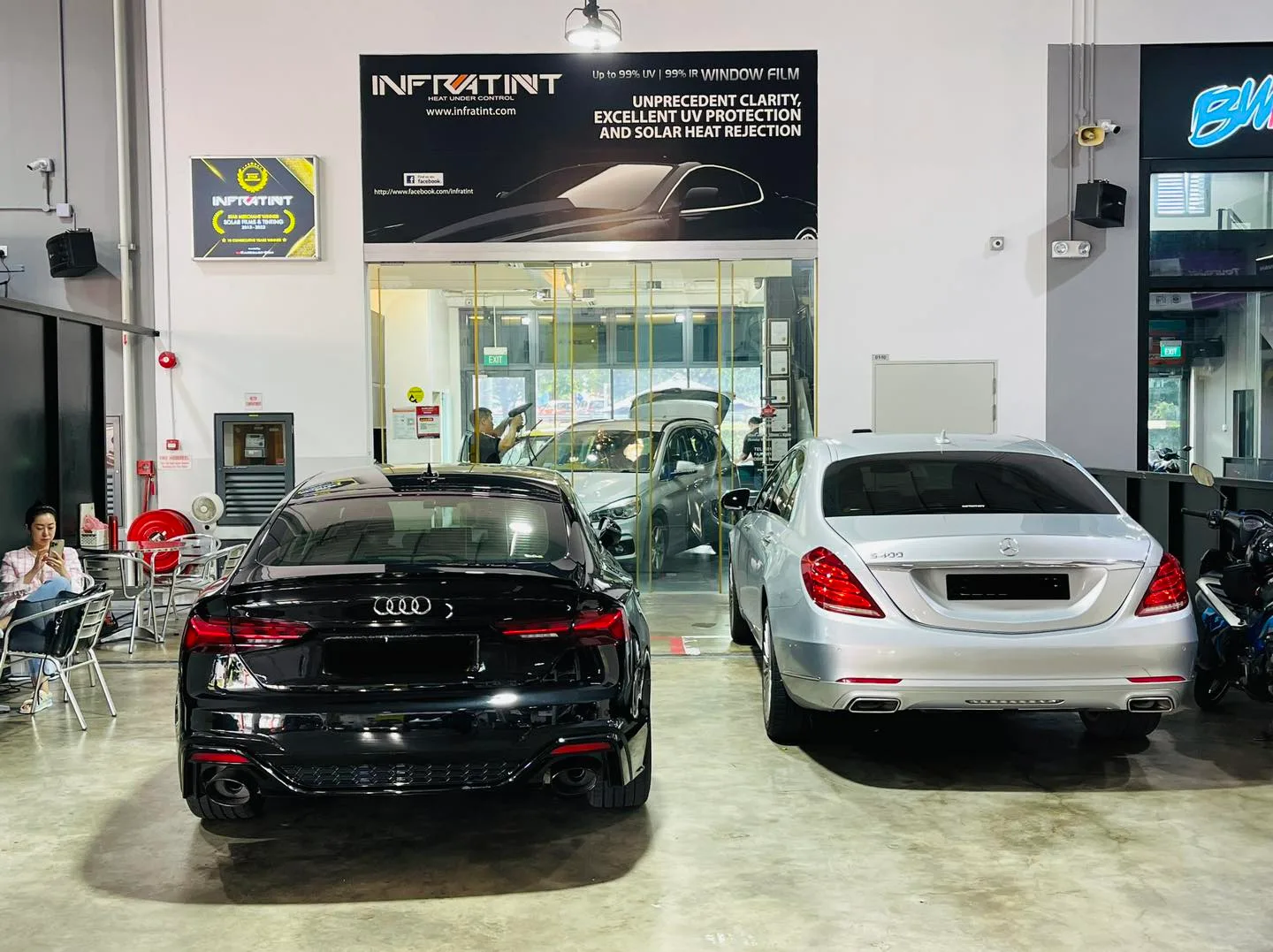 Black Audi sedan and silver Mercedes-Benz S-Class parked rear-on at Infratint Singapore