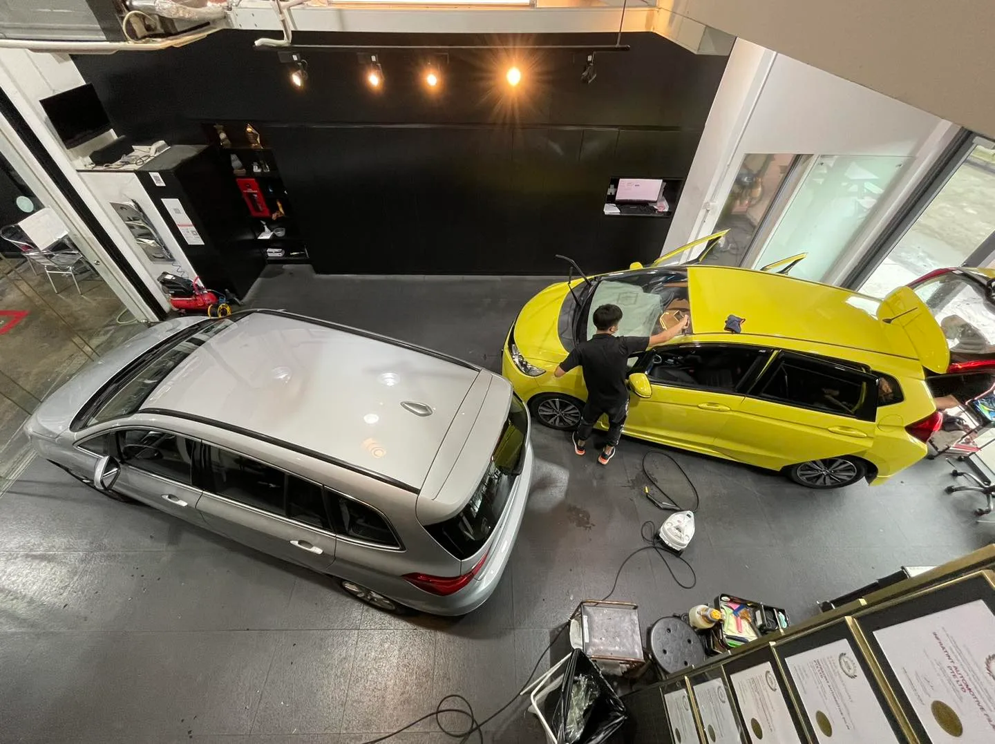 Overhead view of a silver wagon and yellow Honda Fit at Infratint Singapore