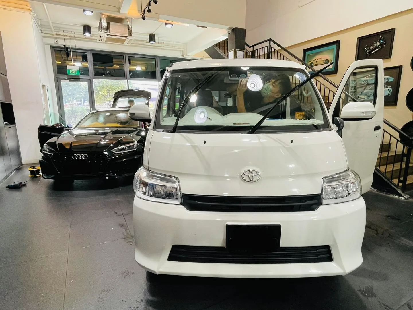 White Toyota MPV and black Audi sedan at Infratint Singapore for window film