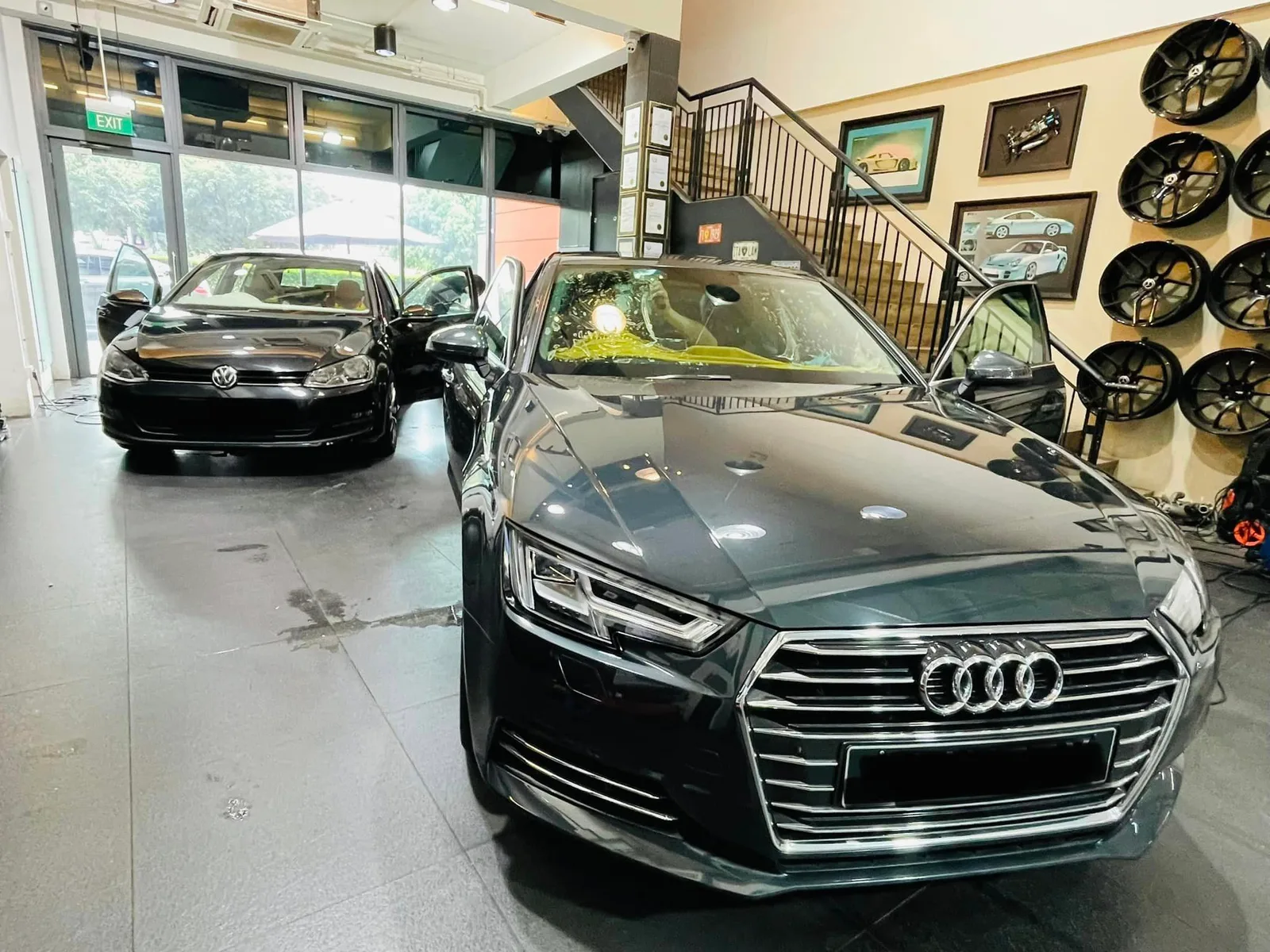 Dark green Audi sedan and black Volkswagen Golf inside the Infratint Singapore bay