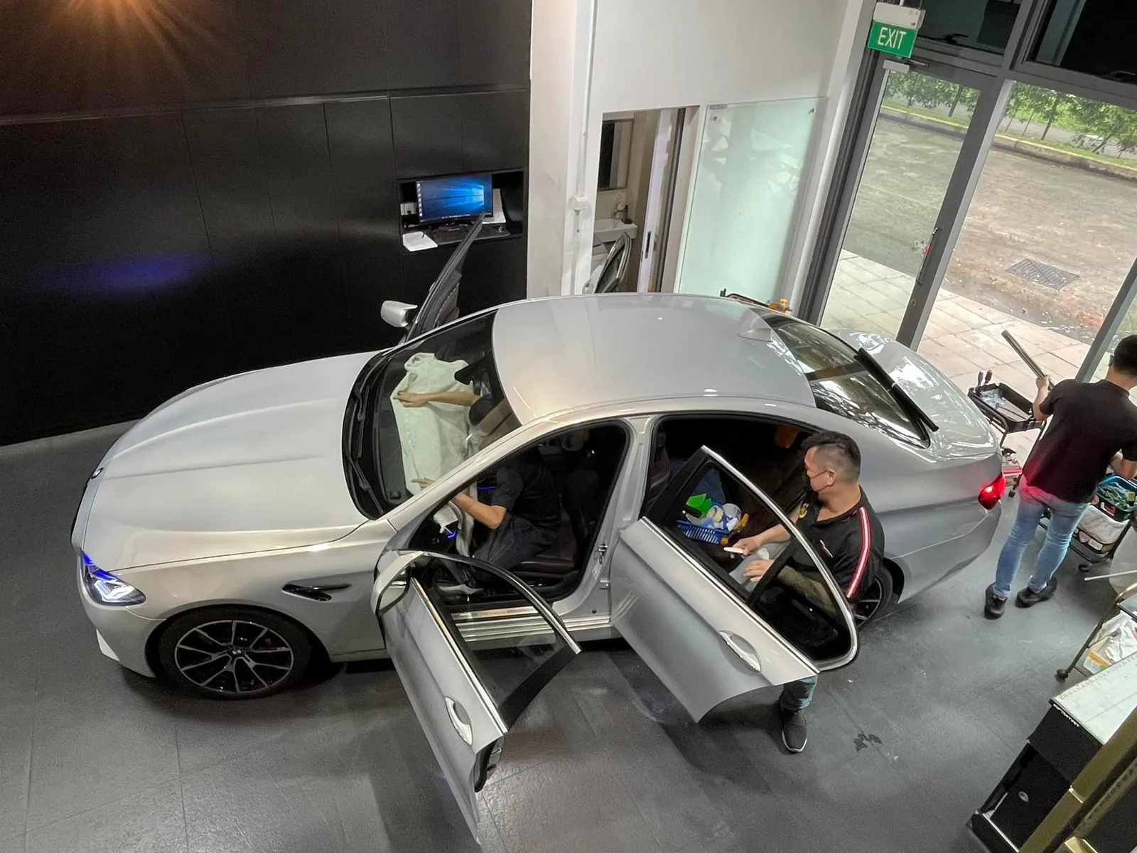Overhead view of a silver BMW 5 Series being tinted at Infratint Singapore