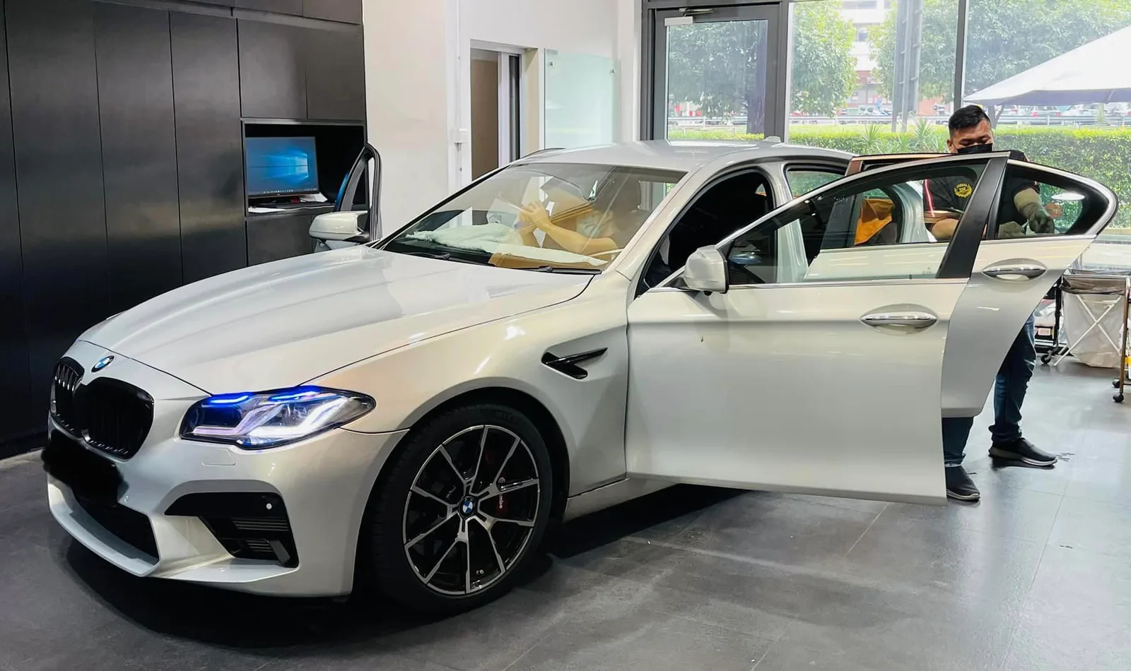 Silver BMW 5 Series side view during window film install at Infratint Singapore