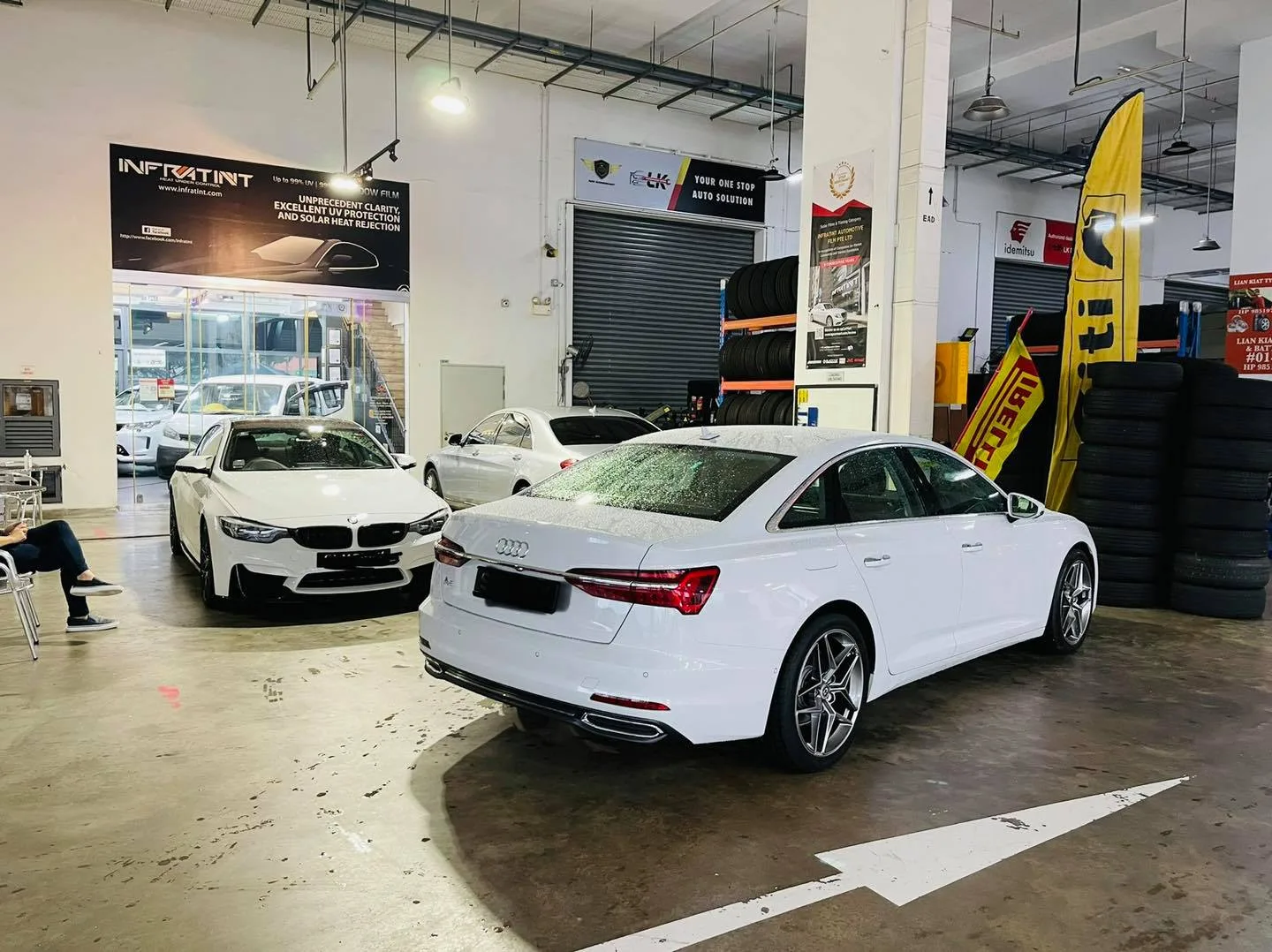 White BMW and white Audi sedan parked at Infratint Singapore for tinting