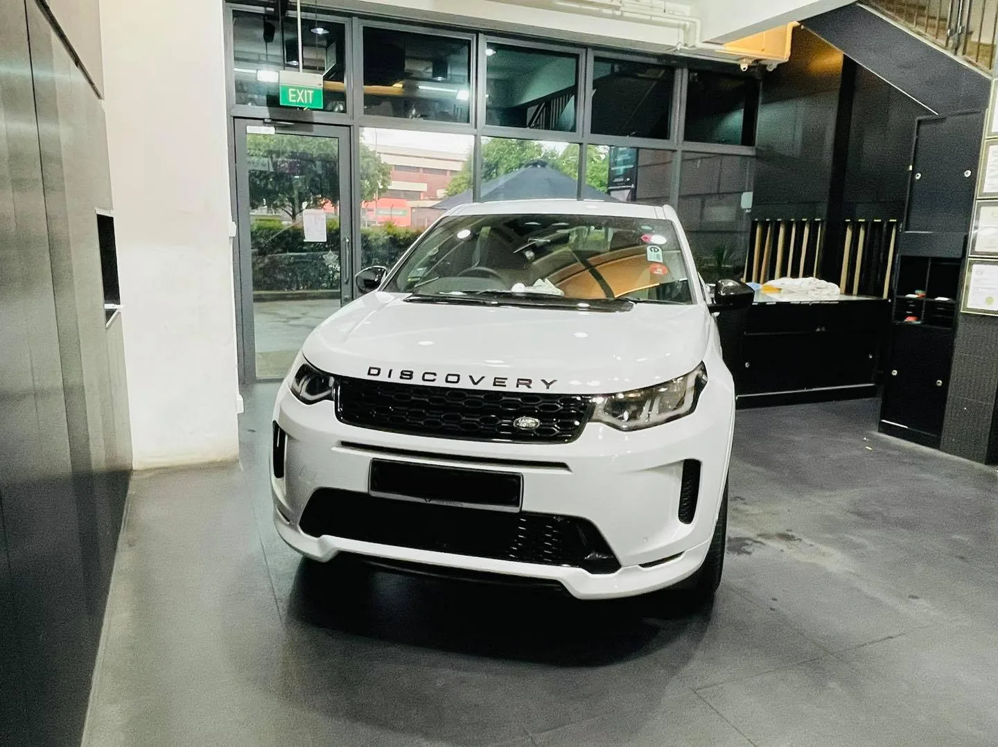 White Land Rover Discovery Sport front view at Infratint Singapore for window tinting