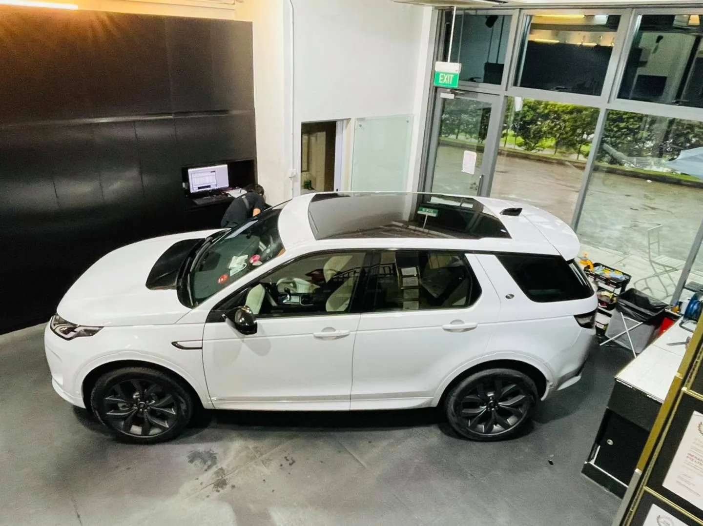 Overhead view of a white Land Rover Discovery Sport with tinted panoramic roof at Infratint Singapore