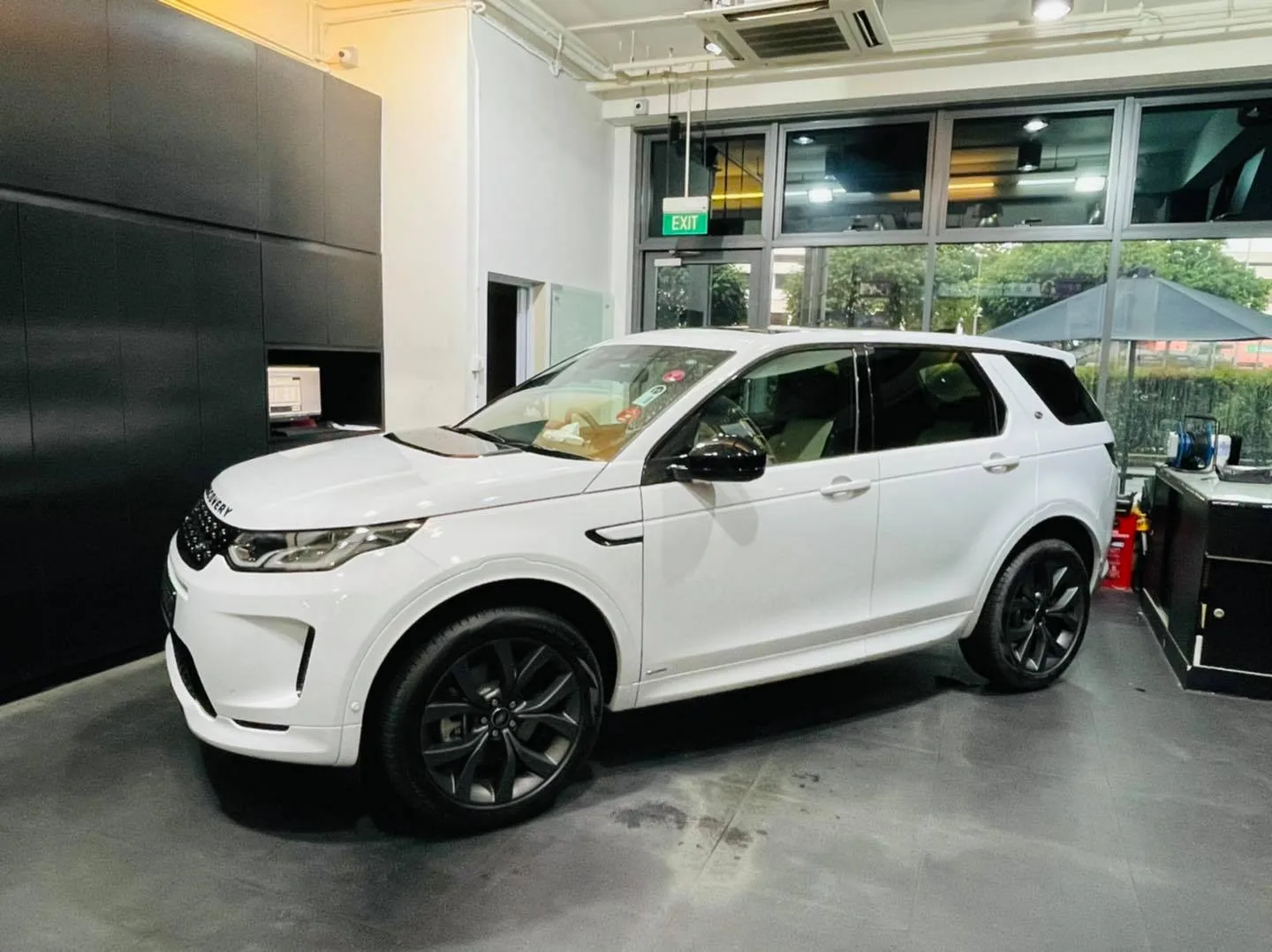 White Land Rover Discovery Sport side profile inside the Infratint Singapore bay