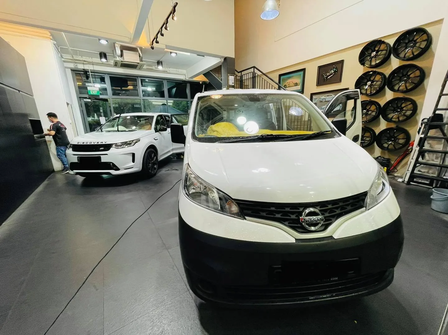White Nissan NV200 van at Infratint Singapore beside a wheel display