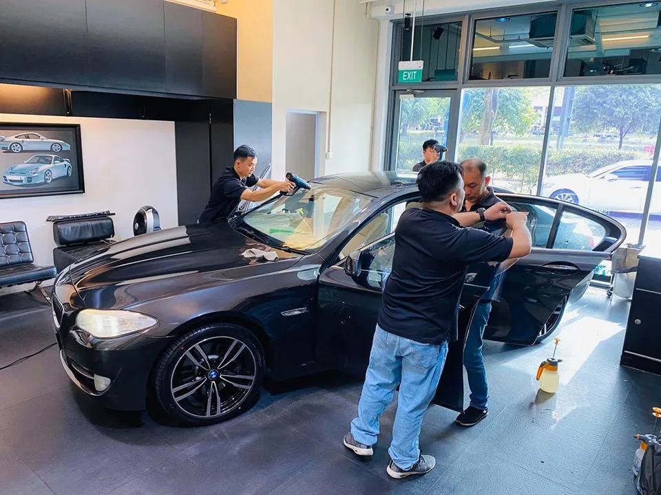 Black BMW 5 Series having heat-shrink and door tint applied at Infratint Singapore