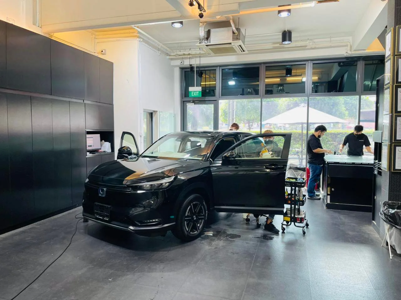 Black Honda SUV being prepared for window tinting at Infratint Singapore