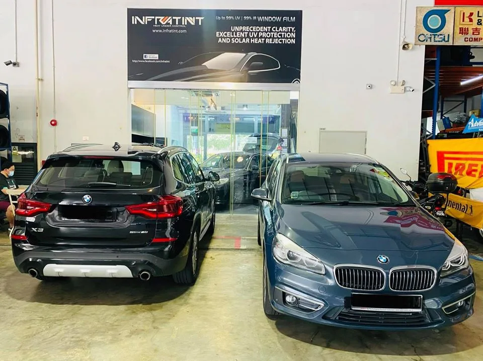 Black BMW X3 and teal BMW 2 Series Tourer lined up at Infratint Singapore
