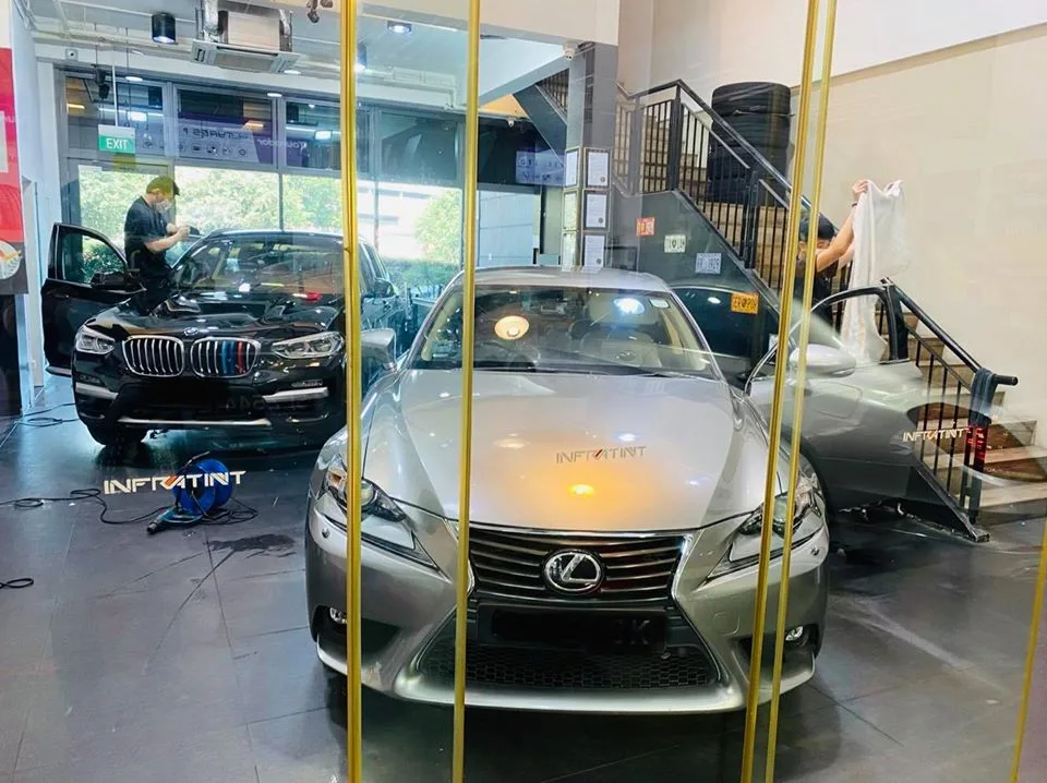 Silver Lexus IS and black BMW X3 being tinted at Infratint Singapore
